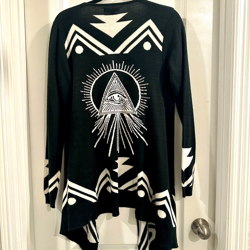 Long black and white patterned cardigan sweater.